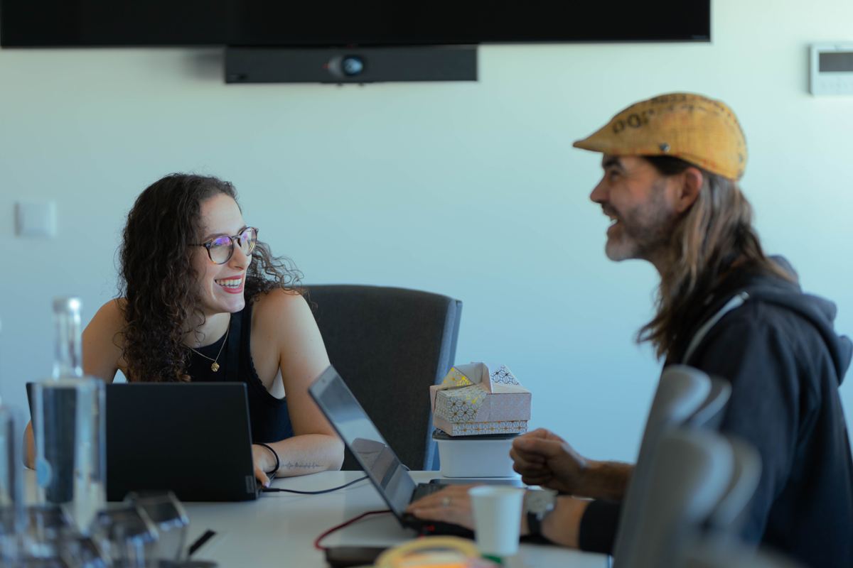 Two participants talking across their laptops